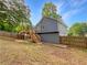 Fenced backyard with wooden deck and stairway at 5080 Brownwood Dr, Powder Springs, GA 30127