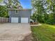 Two-car garage with ample parking space and manicured landscaping at 5080 Brownwood Dr, Powder Springs, GA 30127