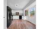 Bright kitchen features white cabinets, wood flooring and modern appliances at 5080 Brownwood Dr, Powder Springs, GA 30127