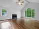 Bright living room featuring a fireplace, large windows, and vaulted ceilings at 5080 Brownwood Dr, Powder Springs, GA 30127