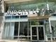 Exterior shot of MidCity Lofts entrance with a modern glass facade and signage at 845 Spring Nw St # 129, Atlanta, GA 30308