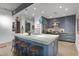 Contemporary kitchen boasts a spacious island, stylish stools, modern lighting, and blue cabinets at 845 Spring Nw St # 129, Atlanta, GA 30308