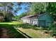 Exterior view of a fenced-in backyard with green grass and trees at 1595 Lake Lucerne Rd Sw, Lilburn, GA 30047