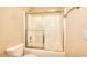 Bathroom featuring shower-tub combination with glass sliding doors, toilet, and granite vanity at 1595 Lake Lucerne Rd Sw, Lilburn, GA 30047