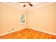 Bedroom featuring ceiling fan, window, and hardwood floors at 1595 Lake Lucerne Rd Sw, Lilburn, GA 30047