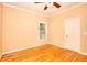Bedroom featuring ceiling fan, window, and hardwood floors at 1595 Lake Lucerne Rd Sw, Lilburn, GA 30047