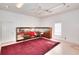 Large bonus room with display cases, rug, and natural light at 1595 Lake Lucerne Rd Sw, Lilburn, GA 30047