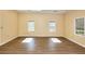 A spacious and sunlit bonus room featuring updated flooring and large windows for lots of natural light at 1595 Lake Lucerne Rd Sw, Lilburn, GA 30047