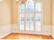 Bright dining room boasts hardwood floors, wainscoting and large arched windows with shutters at 1595 Lake Lucerne Rd Sw, Lilburn, GA 30047