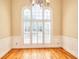 Bright dining room boasts hardwood floors, wainscoting and large arched windows with shutters at 1595 Lake Lucerne Rd Sw, Lilburn, GA 30047