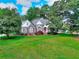 Well manicured lawn and landscaped front yard make this home picturesque and inviting at 1595 Lake Lucerne Rd Sw, Lilburn, GA 30047