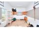 View of messy garage with storage and natural light at 1595 Lake Lucerne Rd Sw, Lilburn, GA 30047