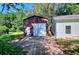 Detached red and white garage with roll-up door at 1595 Lake Lucerne Rd Sw, Lilburn, GA 30047