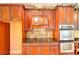 Gourmet kitchen features custom cabinetry, granite countertops, and stainless steel appliances at 1595 Lake Lucerne Rd Sw, Lilburn, GA 30047