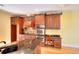 Bright kitchen with custom wood cabinets, stainless steel appliances, stone countertops and hardwood flooring at 1595 Lake Lucerne Rd Sw, Lilburn, GA 30047