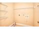 Laundry room with white wire shelving and utility connections at 1595 Lake Lucerne Rd Sw, Lilburn, GA 30047