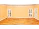 Expansive living room features hardwood floors and multiple windows with privacy shutters at 1595 Lake Lucerne Rd Sw, Lilburn, GA 30047
