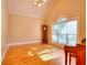 Sun-filled living room features hardwood floors, traditional windows and a vintage grandfather clock at 1595 Lake Lucerne Rd Sw, Lilburn, GA 30047