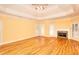 Bright living room featuring hardwood floors, fireplace and tray ceiling at 1595 Lake Lucerne Rd Sw, Lilburn, GA 30047