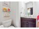 Elegant bathroom with granite countertop, dark wood cabinet, decorative shelves and a framed mirror reflecting stylish light fixture at 1802 Dekalb Ne Ave, Atlanta, GA 30307