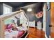 Charming bedroom with wood floors, modern lighting fixture, and whimsical canopy bed filled with pillows and stuffed animals at 1802 Dekalb Ne Ave, Atlanta, GA 30307
