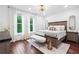 Bright and airy bedroom with hardwood floors, large windows, stylish lighting, and modern furniture at 1802 Dekalb Ne Ave, Atlanta, GA 30307