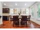Elegant dining area with dark wood table, hardwood floors, recessed lighting, and modern wall art at 1802 Dekalb Ne Ave, Atlanta, GA 30307