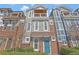 Attractive two-story home with a balcony, brick accents, professional landscaping, and a vibrant blue front door at 1802 Dekalb Ne Ave, Atlanta, GA 30307