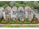 Charming townhomes featuring a mix of brick and siding exteriors, private balconies, and colorful doors at 1802 Dekalb Ne Ave, Atlanta, GA 30307