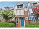 Charming two-story home with a balcony, brick accents, manicured landscaping, and a bright blue front door at 1802 Dekalb Ne Ave, Atlanta, GA 30307