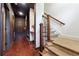 Hallway featuring hardwood floors, a staircase with wrought iron spindles, and a dark accent wall at 1802 Dekalb Ne Ave, Atlanta, GA 30307
