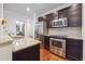 Modern kitchen with granite countertops, stainless steel appliances, dark wood cabinets, and subway tile backsplash at 1802 Dekalb Ne Ave, Atlanta, GA 30307
