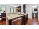 Kitchen island with a stainless dishwasher, double sink, granite counters and view into living room at 1802 Dekalb Ne Ave, Atlanta, GA 30307