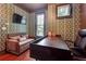 A cozy home office with a daybed, dark wood desk, and vibrant wallpaper, perfect for work and relaxation at 1802 Dekalb Ne Ave, Atlanta, GA 30307
