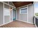 Inviting covered patio with wooden floors and walls, a blue door, and natural light, perfect for relaxation at 1802 Dekalb Ne Ave, Atlanta, GA 30307