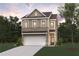 Charming two-story home with brick and siding, features a two-car garage, and a well-manicured lawn at 1886 Copelyn Reese Court (Lot 165), Lawrenceville, GA 30043