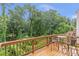 Outdoor deck with table and seating offers relaxing views of the surrounding trees at 2735 Maple Park Pl # 32, Cumming, GA 30041