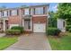 Charming brick townhome with a one-car garage and well-manicured landscaping at 2735 Maple Park Pl # 32, Cumming, GA 30041