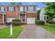 Attractive townhouse with brick and siding, well-maintained landscaping, and a private driveway at 2735 Maple Park Pl # 32, Cumming, GA 30041