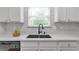 Bright kitchen showcasing a deep sink, stylish faucet, and white subway tile backsplash at 2735 Maple Park Pl # 32, Cumming, GA 30041