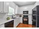 Well-lit kitchen featuring white cabinets, quartz countertops, and stainless steel appliances at 2735 Maple Park Pl # 32, Cumming, GA 30041