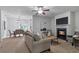 Open-concept living room with fireplace seamlessly connects to the dining area at 2735 Maple Park Pl # 32, Cumming, GA 30041
