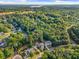 Expansive aerial view showcases a neighborhood surrounded by lush greenery and distant water at 321 River Green Ave, Canton, GA 30114