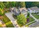 Aerial view showcasing a beautiful home with lush landscaping, a long driveway, and a welcoming porch at 321 River Green Ave, Canton, GA 30114