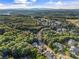 Lush green aerial view with winding roads leading through a neighborhood and a distant mountain view at 321 River Green Ave, Canton, GA 30114