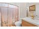 Modern bathroom featuring a wood vanity and mirror, a sink, and a shower/tub with a patterned curtain at 321 River Green Ave, Canton, GA 30114