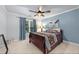 Comfortable bedroom featuring neutral walls, plush carpet, ceiling fan, and cozy furnishings at 321 River Green Ave, Canton, GA 30114