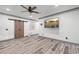 Spacious living area featuring wood-look flooring, barn doors, and modern entertainment center at 321 River Green Ave, Canton, GA 30114