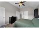 Bedroom with ceiling fan, closet and black dresser at 6840 Canyon Creek Way, Cumming, GA 30028