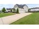 Spacious driveway leading to a well-maintained home with a three-car garage at 6840 Canyon Creek Way, Cumming, GA 30028